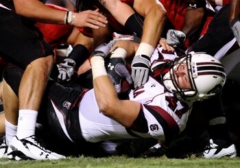 RALEIGH, NC - SEPTEMBER 3: Fullback Patrick DiMarco $47 of the South Carolina Gamecocks is tackled during the game against the North Carolina State Wolfpack at Carter-Finley Stadium on September 3, 2009 in Raleigh, North Carolina. (Photo by Streeter Lecka