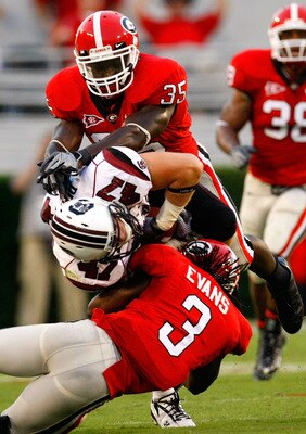 ATHENS, GA - SEPTEMBER 12:  Rennie Curran #35 and Bryan Evans #3 of the Georgia Bulldogs tackle Patrick DiMarco #47 of the South Carolina Gamecocks at Sanford Stadium on September 12, 2009 in Athens, Georgia.  (Photo by Kevin C. Cox/Getty Images)