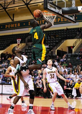 ORLANDO, FL - NOVEMBER 27:  Quincy Acy #4 of the Baylor Bears attempts a shot against Rashard McGiill #23 of the Iona Gaels during the Old Spice Classic at Disney's Milk House on November 27, 2009 in Orlando, Florida.  (Photo by Sam Greenwood/Getty Images