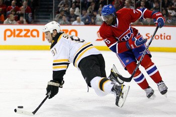MONTREAL, CANADA - DECEMBER 16:  P.K. Subban #76 of the Montreal Canadiens trips Marc Savard #91 of the Boston Bruins during the NHL game at the Bell Centre on December 16, 2010 in Montreal, Quebec, Canada.  The Canadiens defeated the Bruins 4-3.  (Photo