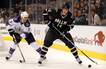 DALLAS, TX - JANUARY 17:  Left wing Jamie Benn #14 of the Dallas Stars skates the puck past Rob Scuderi #7 of the Los Angeles Kings at American Airlines Center on January 17, 2011 in Dallas, Texas.  (Photo by Ronald Martinez/Getty Images)