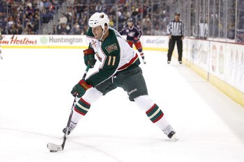 COLUMBUS,OH - NOVEMBER 06:  John Madden #11 of the Minnesota Wild skates with the puck against the Columbus Blue Jackets on November 6, 2010 at Nationwide Arena in Columbus, Ohio.  (Photo by John Grieshop/Getty Images)