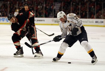 CHICAGO, IL - DECEMBER 22: Steve Sullivan #26 of the Nashville Predators tries to control the puck under pressure from Brent Seabrook #7 of the Chicago Blackhawks at the United Center on December 22, 2010 in Chicago, Illinois. The Blackhawks defeated the