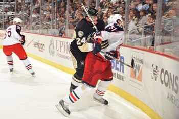 PITTSBURGH, PA - FEBRUARY 8:  Matt Cooke #24 of the Pittsburgh Penguins checks Fedor Tyutin #51 of the Columbus Blue Jackets in the first period on February 8, 2011 at CONSOL Energy Center in Pittsburgh, Pennsylvania. Cooke was assessed a five-minute majo