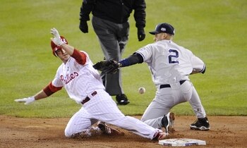 PHILADELPHIA - NOVEMBER 02:  Chase Utley #26 of the Philadelphia Phillies steals second base as shortstop Derek Jeter #2 of the New York Yankees drops the ball in the bottom of the third inning of Game Five of the 2009 MLB World Series at Citizens Bank Pa