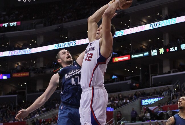 LOS ANGELES, CA - DECEMBER 20:  Blake Griffin #32 of the Los Angeles Clippers drives past Kevin Love #42 of the Minnesota Timberwolves for a dunk during the second half at Staples Center on December 20, 2010 in Los Angeles, California. The Clippers defeat