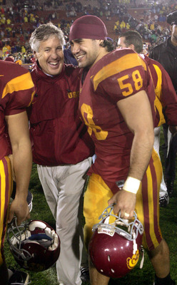 LOS ANGELES - NOVEMBER 27:  Head caoch Pete Carroll of the USC Trojans celebrates with linebacker Lofa Tatupu #58 after the game with the Notre Dame Fighting Irish on November 27, 2004 at the Los Angeles Coliseum in Los Angeles, California.  USC won 41-10