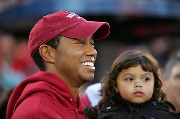 PALO ALTO, CA - NOVEMBER 21:  Honorary Standford Cardinal captain Tiger Woods holds his daugher, Sam, on the sidelines before the Cardinal game against the California Bears at Stanford Stadium on November 21, 2009 in Palo Alto, California.  (Photo by Ezra