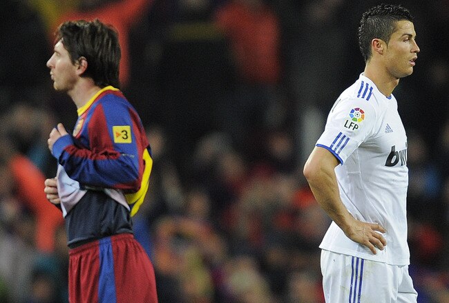 BARCELONA, SPAIN - NOVEMBER 29:  Cristiano Ronaldo of Real Madrid (R) and Lionel Messi of FC Barcelona look on during the La Liga match between Barcelona and Real Madrid at the Camp Nou Stadium on November 29, 2010 in Barcelona, Spain.  Barcelona won the