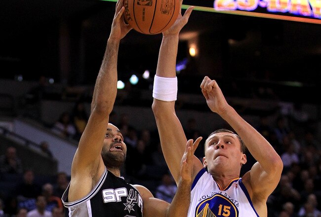 OAKLAND, CA - JANUARY 24:  Tony Parker #9 of the San Antonio Spurs goes up for a shot against Andris Biedrins #15 of the Golden State Warriors at Oracle Arena on January 24, 2011 in Oakland, California.  NOTE TO USER: User expressly acknowledges and agree