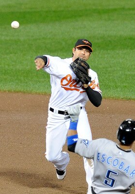 BALTIMORE - SEPTEMBER 13:  Brian Roberts #1 of the Baltimore Orioles forces out Yunel Escobar #5 of the Toronto Blue Jays to start a double play at Camden Yards on September 13, 2010 in Baltimore, Maryland.  (Photo by Greg Fiume/Getty Images)