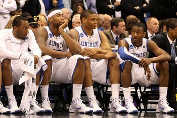 SYRACUSE, NY - MARCH 27:  (L-R) Ramon Harris #5, DeMarcus Cousins #15, Daniel Orton #33 and John Wall #11 of the Kentucky Wildcats look on dejected from the bench in the final minute of the second half against the West Virginia Mountaineers during the eas