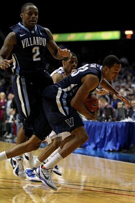 ROSEMONT, IL - FEBRUARY 19: Dominic Cheek #23 of the Villanova Wildcats controls the ball in front of teammate Maalik Wayns #2 and Jeremiah Kelly #11 of the DePaul Blue Demons at the Allstate Arena on February 19, 2011 in Rosemont, Illinois. Villanova def