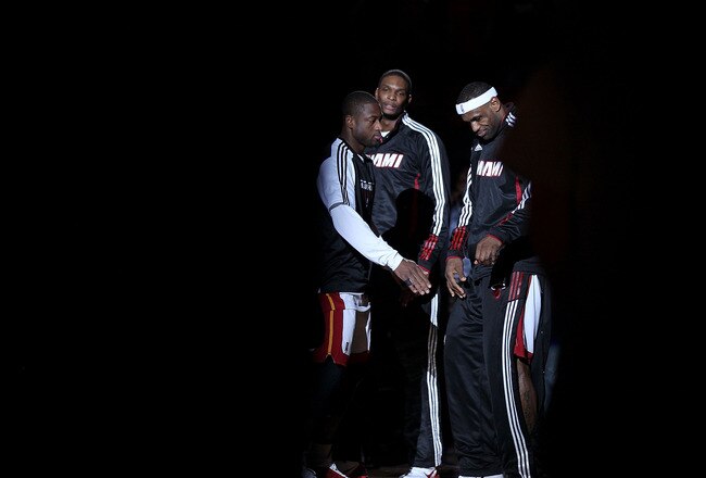 MIAMI, FL - FEBRUARY 25:  LeBron James #6, Dwyane Wade #3 and Chris Bosh #1 of the Miami Heat talk during a game against the Washington Wizards at American Airlines Arena on February 25, 2011 in Miami, Florida. NOTE TO USER: User expressly acknowledges an