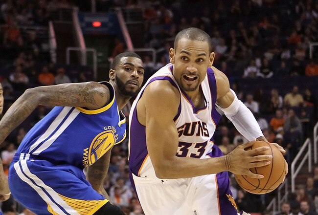 PHOENIX, AZ - FEBRUARY 10:  Grant Hill #33 of the Phoenix Suns drives the ball past Dorell Wright #1 of the Golden State Warriors during the NBA game at US Airways Center on February 10, 2011 in Phoenix, Arizona.  The Suns defeated the Warriors 112-88.  N