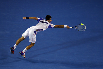 MELBOURNE, AUSTRALIA - JANUARY 30:  Novak Djokovic of Serbia plays a backhand in his men's final match against Andy Murray of Great Britain during day fourteen of the 2011 Australian Open at Melbourne Park on January 30, 2011 in Melbourne, Australia.  (Ph