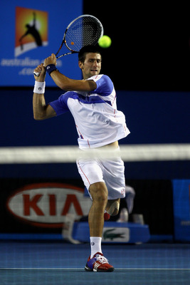 MELBOURNE, AUSTRALIA - JANUARY 30:  Novak Djokovic of Serbia plays a forehand in his men's final match against Andy Murray of Great Britain during day fourteen of the 2011 Australian Open at Melbourne Park on January 30, 2011 in Melbourne, Australia.  (Ph