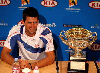 MELBOURNE, AUSTRALIA - JANUARY 30:  Novak Djokovic of Serbia poses with the Norman Brookes Challenge Cup in the press conference following his win in the men's final match against Andy Murray of Great Britain during day fourteen of the 2011 Australian Ope
