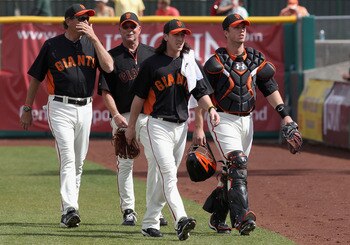 SCOTTSDALE, AZ - MARCH 01:  Starting pitcher Tim Lincecum ##55 and Buster Posey #28 of the San Francisco Giants walk to the dugout before during the spring training game against the Chicago Cubs at Scottsdale Stadium on March 1, 2011 in Scottsdale, Arizon