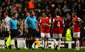 NEWCASTLE UPON TYNE, ENGLAND - FEBRUARY 05:  Cesc Fabregas and Tomas Rosicky of Arsenal talk to referee Phil Dowd at the final whistle during the Barclays Premier League match between Newcastle United and Arsenal at St James' Park on February 5, 2011 in N