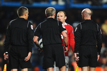 LONDON, ENGLAND - MARCH 01:  Wayne Rooney of Manchester United exchanges words with referee Martin Atkinson after the Barclays Premier League match between Chelsea and Manchester United at Stamford Bridge on March 1, 2011 in London, England.  (Photo by Cl