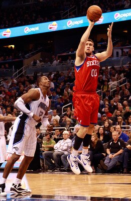 ORLANDO, FL - DECEMBER 18:  Spencer Hawes #00 of the Philadelphia 76ers attempts a shot against Dwight Howard #12 of the Orlando Magic during the game at Amway Arena on December 18, 2010 in Orlando, Florida.  NOTE TO USER: User expressly acknowledges and