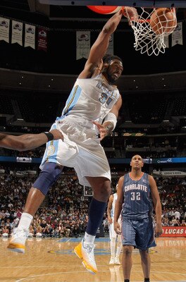 DENVER, CO - MARCH 02:  Nene #31 of the Denver Nuggets dunks the ball in front of Boris Diaw #32 of the Charlotte Bobcats at the Pepsi Center on March 2, 2011 in Denver, Colorado. The Nuggets defeated the Bobcats 120-80.NOTE TO USER: User expressly acknow