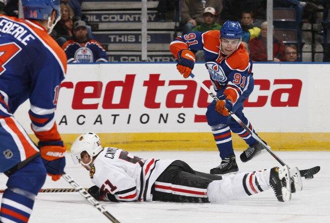 EDMONTON, CANADA - NOVEMBER 17: Magnus Paajarvi #91 of the Edmonton Oilers tries to flip a pass over to teammate Jordan Eberle #14 as Brian Campbell #51 of the Chicago Blackhawks breaks up the play  in third-period action.  Chicago won the game 5-0 at Rex
