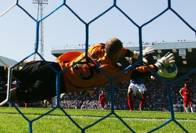 PORTSMOUTH, UNITED KINGDOM - SEPTEMBER 15:  Pepe Reina of Liverpool saves a penalty from Kanu of Portsmouth  during the Barclays Premier League match between Portsmouth and Liverpool at Fratton Park on September 15, 2007 in Portsmouth, England.  (Photo by