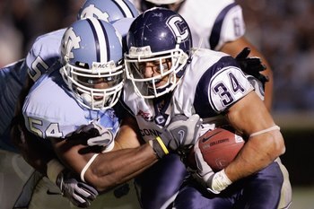 CHAPEL HILL, NC - OCTOBER 4:  Donald Brown #34 of the Connecticut Huskies carries the ball against Bruce Carter #54 of the North Carolina Tar Heels during the game at Kenan Stadium on October 4, 2008 in Chapel Hill, North Carolina.  (Photo by Kevin C. Cox