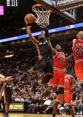 MIAMI, FL - MARCH 06:  Dwyane Wade #3 of the Miami Heat shoots over Luol Deng #9 of the Chicago Bulls during a game at American Airlines Arena on March 6, 2011 in Miami, Florida. NOTE TO USER: User expressly acknowledges and agrees that, by downloading an