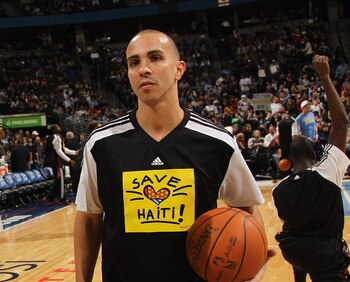 DENVER, CO - JANUARY 13:  (L-R) Chauncey Billups #1 of the Denver Nuggets and Carlos Arroyo #8 of the Miami Heat talk during pregame as the teams warmed up in 'Save Haiti' shirts to promote the Haiti Relief Fund at the Pepsi Center on January 13, 2011 in