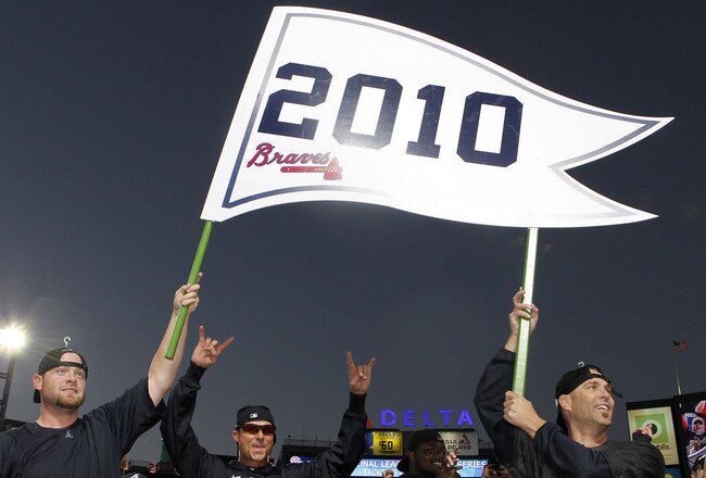ATLANTA - OCTOBER 3:  Catcher Brian McCann #16 and pitcher Tim Hudson #15 of the Atlanta Braves hold up a 2010 playoff banner during the on-field celebration after the game against the Atlanta Braves Philadelphia Phillies at Turner Field on October 3, 201