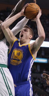 BOSTON, MA - MARCH 04: David Lee #10 of the Golden State Warriors takes a shot as Jeff Green #8 of the Boston Celtics defends on March 4, 2011 at the TD Garden in Boston, Massachusetts.  The Celtics defeated the Warriors 107-103. NOTE TO USER: User expres