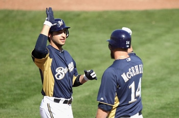 PHOENIX, AZ - MARCH 03:  Ryan Braun #8 of the Milwaukee Brewers high fives teammate Casey McGehee #14 after Braun hit a 2 run home run against the Oakland Athletics during the third inning of the spring training game at Maryvale Baseball Park on March 3,