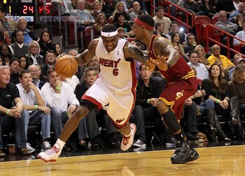 MIAMI, FL - DECEMBER 15:  LeBron James #6 of the Miami Heat dribbles around Daniel Gibson #1 of the Cleveland Cavaliers during a game  at American Airlines Arena on December 15, 2010 in Miami, Florida. NOTE TO USER: User expressly acknowledges and agrees 