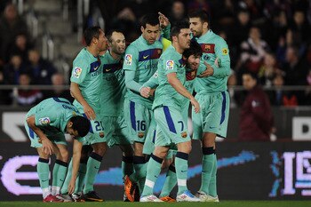 MALLORCA, SPAIN - FEBRUARY 26:  Lionel Messi of Barcelona (2ndL) celebrates with his teammates after scoring his first team's goal during the La Liga match between Mallorca and Barcelona at Iberstar Stadium on February 26, 2011 in Mallorca, Spain.  (Photo