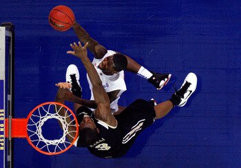 ATLANTA, GA - MARCH 12:  Kenny Boynton #1 of the Florida Gators shoots against Festus Ezeli #3 of the Vanderbilt Commodores during the semifinals of the SEC Men's Basketball Tournament at Georgia Dome on March 12, 2011 in Atlanta, Georgia.  (Photo by Kevi