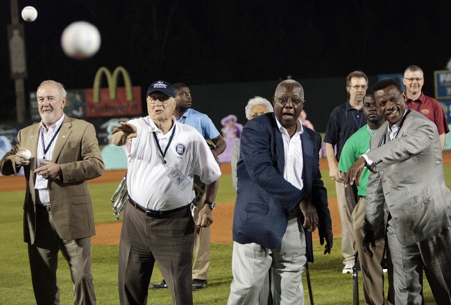 MOBILE, AL - APRIL 14:  Baseball Hall of Famers (L-R) Bruce Sutter, Bob Feller, Hank Aaron and Rickey Henderson throw out the first pitch during pre-game ceremonies following the opening the Hank Aaron Museum at the Hank Aaron Stadium on April 14, 2010 in