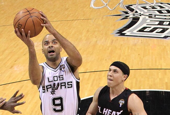 SAN ANTONIO, TX - MARCH 04:  Guard Tony Parker #9 of the San Antonio Spurs takes a shot against Mike Bibby #0 of the Miami Heat at AT&T Center on March 4, 2011 in San Antonio, Texas.   NOTE TO USER: User expressly acknowledges and agrees that, by download