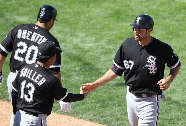 TUCSON, AZ - MARCH 07:   Jordan Danks #67 of the Chicago White Sox high fives manager Ozzie Guillen after Danks scored a run against the Arizona Diamondbacks during the fifth inning of the spring training game at Kino Veterans Memorial Stadium on March 7,
