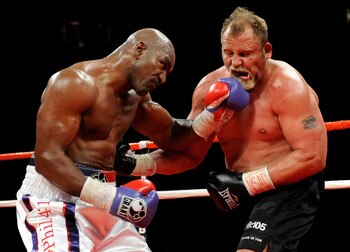 LAS VEGAS - APRIL 10:  Evander Holyfield (L) hits Francois Botha in the seventh round of their heavyweight bout at the Thomas & Mack Center April 10, 2010 in Las Vegas, Nevada. Holyfield won by TKO in the eighth round.  (Photo by Ethan Miller/Getty Images