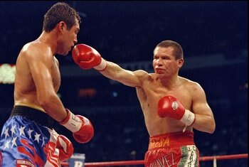 18 Sep 1998:  Julio Cesar Chavez throws a right hand at Oscar De La Hoya during their bout at the Thomas and Mack Center in Las Vegas, Nevada. De La Hoya defeated Chavez by way of a TKO in the 8th round. Mandatory Credit: Jed Jacobsohn  /Allsport