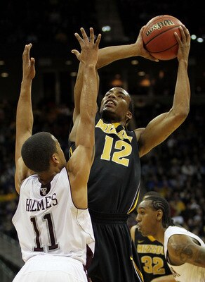 KANSAS CITY, MO - MARCH 10:  Marcus Denmon #12 of the Missouri Tigers goes up for a shot against B.J. Holmes #11 of the Texas A&M Aggies during their quarterfinal game in the 2011 Phillips 66 Big 12 Men's Basketball Tournament at Sprint Center on March 10