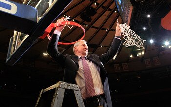 NEW YORK, NY - MARCH 12:  Head coach Jim Calhoun of the Connecticut Huskies cuts down the net after defeating the Louisville Cardinals during the championship of the 2011 Big East Men's Basketball Tournament presented by American Eagle Outfitters at Madis