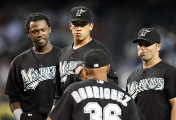PHOENIX - JULY 11:  Infielder Hanley Ramirez #2, pitcher Alex Sanabia #59 and Dan Uggla #6 of the Florida Marlins stand on the mound as manager Edwin Rodriguez #36 walks up during the Major League Baseball game against the Arizona Diamondbacks at Chase Fi