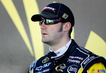 DAYTONA BEACH, FL - FEBRUARY 12:  Paul Menard, driver of the #27 Menards Chevrolet, stands in the garage area during practice for the NASCAR Sprint Cup Series Daytona 500 at Daytona International Speedway on February 12, 2011 in Daytona Beach, Florida.  (