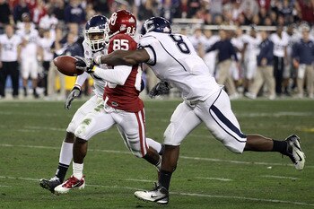 GLENDALE, AZ - JANUARY 01:  Ryan Broyles #85 of the Oklahoma Sooners fumbles the ball as it is stripped by Lawrence Wilson #8 of the Connecticut Huskies alongside Jerome Junior #15 in the second half during the Tostitos Fiesta Bowl at the Universtity of P