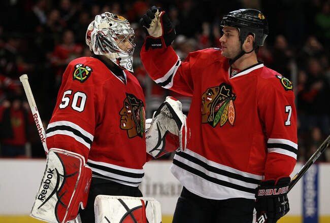 CHICAGO, IL - MARCH 02: Brent Seabrook #7 of the Chicago Blackhawks congratulates teammate Corey Crawford #50 after a win over the Calgary Flames at the United Center on March 2, 2011 in Chicago, Illinois. The Blackhawks defeated the Flames 6-4. (Photo by
