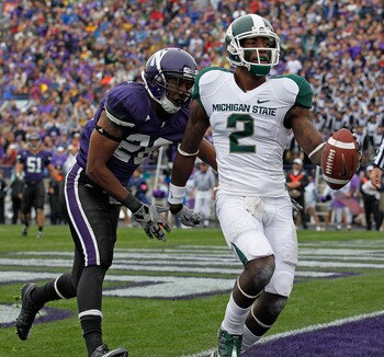 EVANSTON, IL - OCTOBER 23: Mark Dell #2 of the Michigan State Spartans scores a touchdown in front of Justan Vaughn #28 of the Northwestern Wildcats at Ryan Field on October 23, 2010 in Evanston, Illinois. Michigan State defeated Northwestern 35-27. (Phot